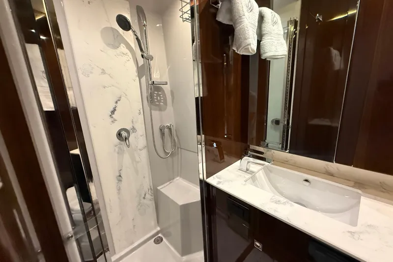  Yacht Photos Pics Luxurious bathroom in 2022 Cruisers Yachts 50 Cantius with modern shower and elegant sink.