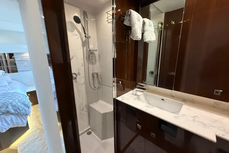  Yacht Photos Pics Luxurious bathroom in 2022 Cruisers Yachts 50 Cantius, featuring elegant fixtures and modern design.