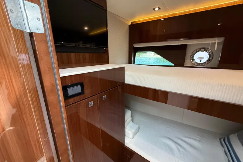  Yacht Photos Pics Luxurious 2022 Cruisers Yachts 50 Cantius cabin with bunk beds and sleek wood finish.