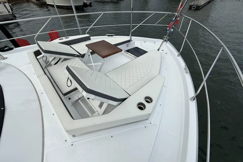  Yacht Photos Pics 2022 Cruisers Yachts 50 Cantius bow with luxurious seating and table on water.