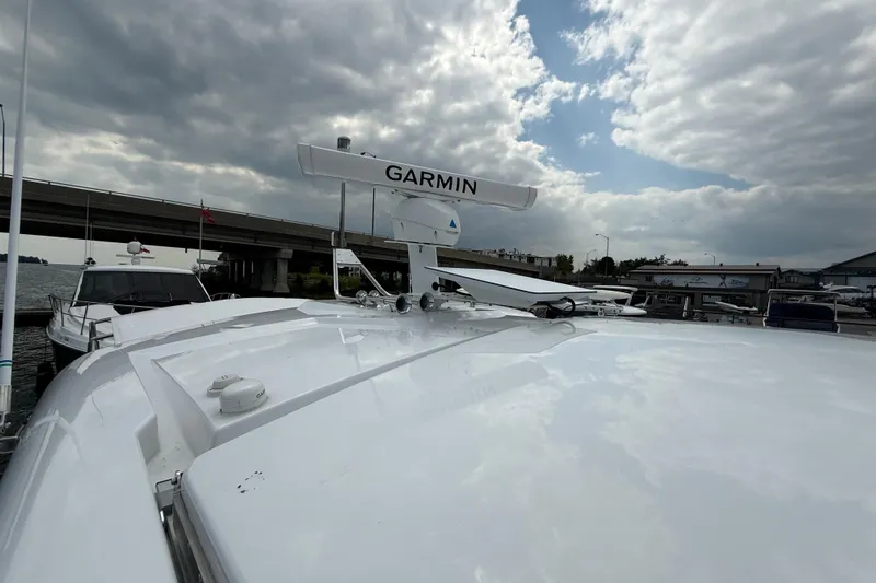  Yacht Photos Pics 2022 Cruisers Yachts 50 Cantius with Garmin radar, docked under cloudy sky.