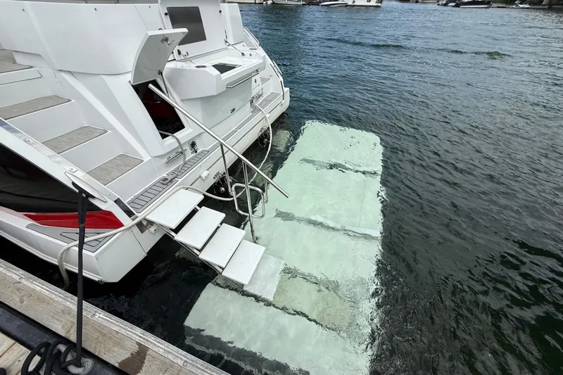  Yacht Photos Pics 2022 Cruisers Yachts 50 Cantius with swim platform on water.