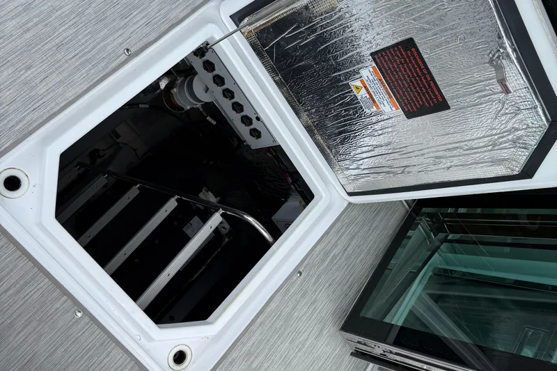  Yacht Photos Pics Open hatch on 2022 Cruisers Yachts 50 Cantius, revealing engine compartment.