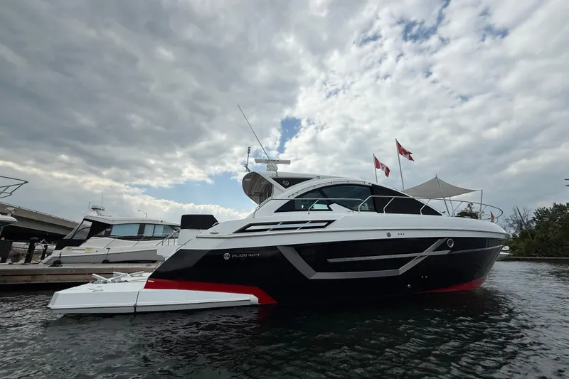  Yacht Photos Pics 2022 Cruisers Yachts 50 Cantius docked under cloudy sky.