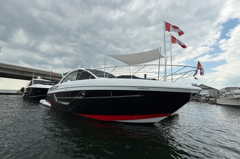  Yacht Photos Pics 2022 Cruisers Yachts 50 Cantius docked, featuring sleek design and Canadian flags.