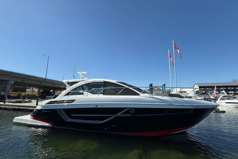  Yacht Photos Pics 2022 Cruisers Yachts 50 Cantius docked, sleek design, blue sky background.