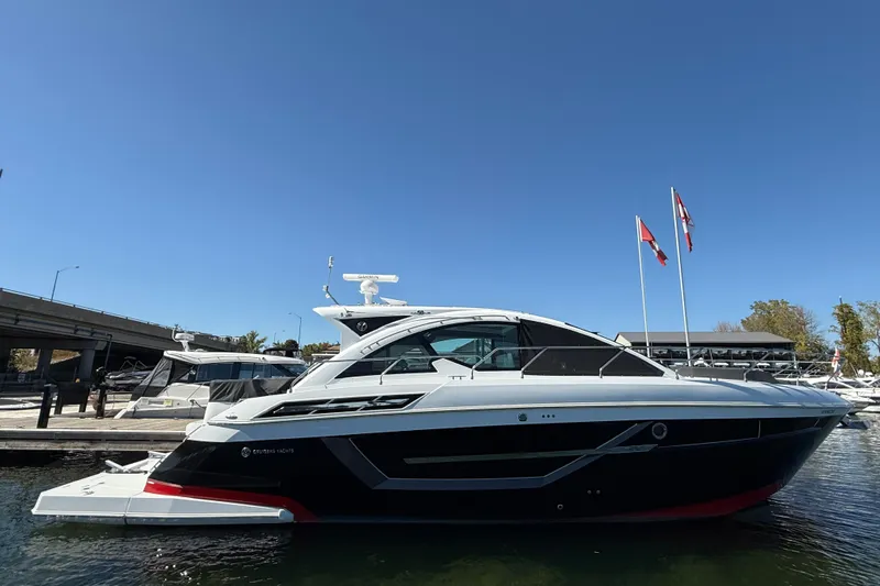  Yacht Photos Pics 2022 Cruisers Yachts 50 Cantius docked, sleek design under clear blue sky.