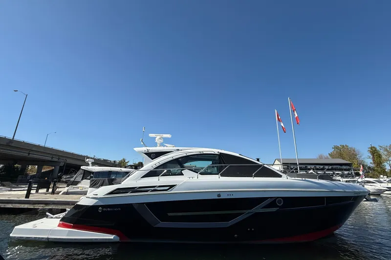  Yacht Photos Pics 2022 Cruisers Yachts 50 Cantius docked under clear blue sky.