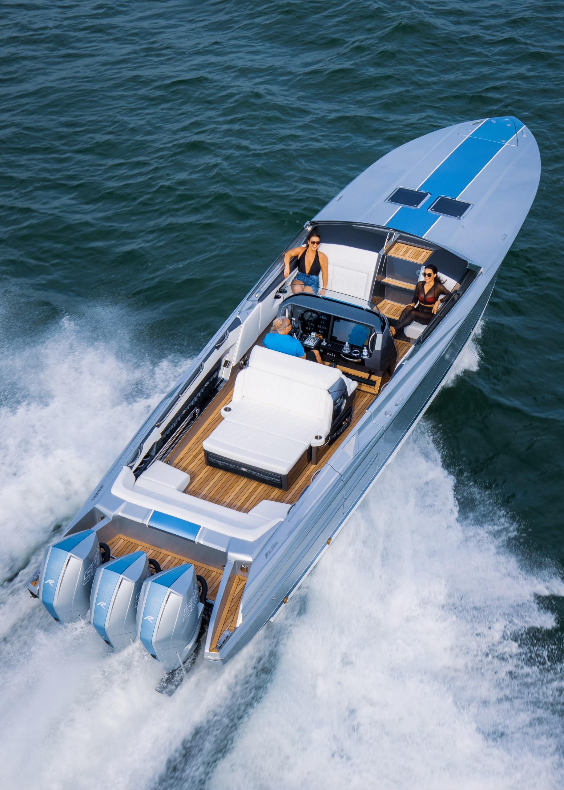2005 Nor-Tech 420 Monte Carlo speedboat cruising on open water, featuring triple outboard engines.