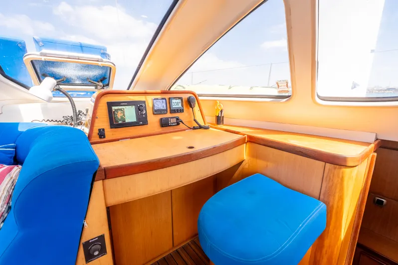 Nina May Yacht Photos Pics Catana 431 yacht interior, 2001 model, featuring navigation equipment and blue seating.