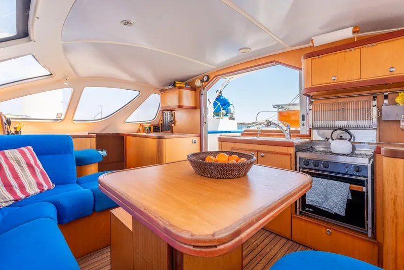 Nina May Yacht Photos Pics Interior of 2001 Catana 431 yacht with cozy seating and modern kitchen.