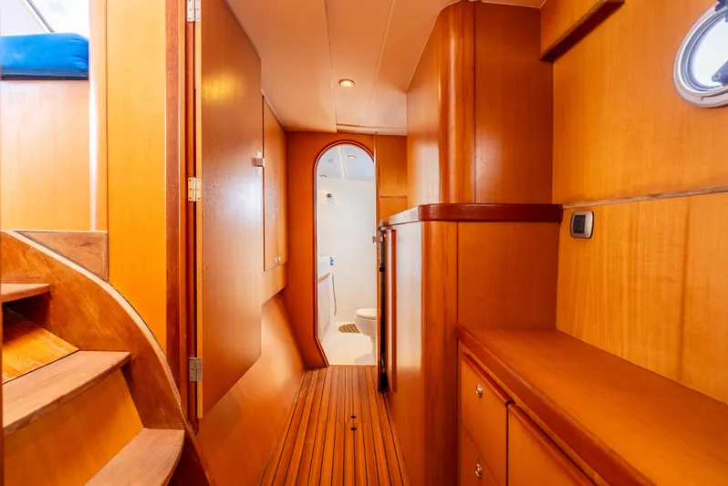 Nina May Yacht Photos Pics Interior of 2001 Catana 431 yacht with wooden finishes and hallway view.