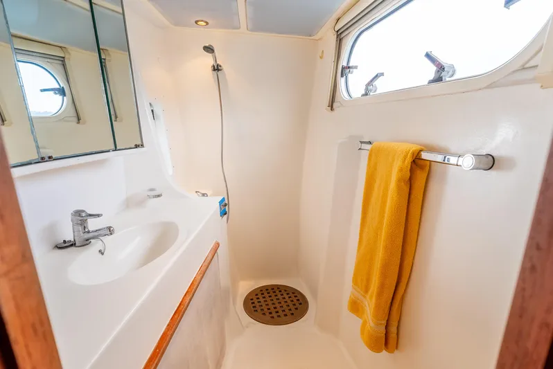 Nina May Yacht Photos Pics Catana 431 yacht bathroom with shower, sink, and yellow towel, 2001 model.