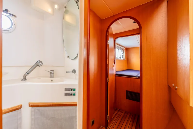 Nina May Yacht Photos Pics Interior of 2001 Catana 431 yacht, featuring a cozy cabin and modern bathroom.