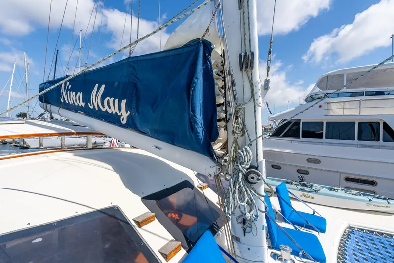 Nina May Yacht Photos Pics Catana 431 sailboat from 2001 docked, featuring blue sail cover and clear sky.