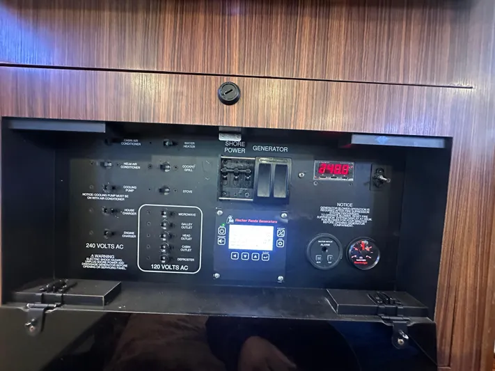  Yacht Photos Pics Control panel of a 2017 Pursuit OS 355 Offshore boat, featuring power switches and gauges.