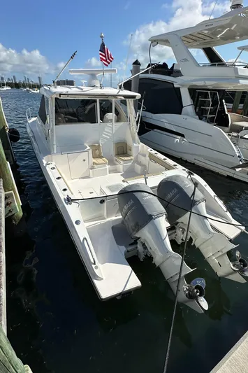 Yacht Photos Pics 2017 Pursuit OS 355 Offshore boat docked, featuring dual outboard engines and sleek design.