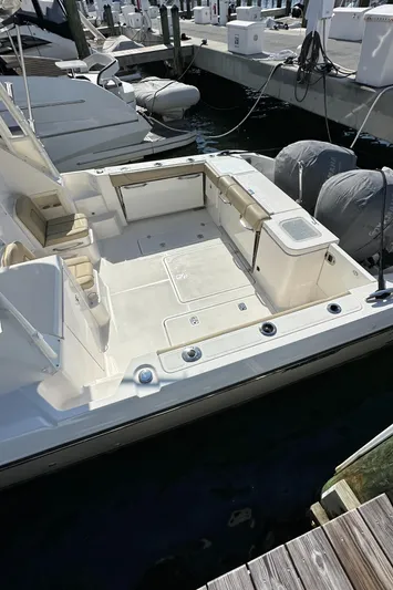  Yacht Photos Pics 2017 Pursuit OS 355 Offshore boat docked, featuring spacious deck and seating area.