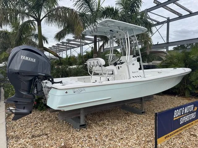 2025 BlackJack 224 boat with Yamaha motor on display, surrounded by palm trees.