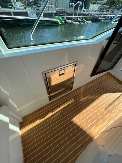 Elixir Yacht Photos Pics 2019 Beneteau Gran Turismo 46 yacht interior with wooden flooring and stainless steel hatch.