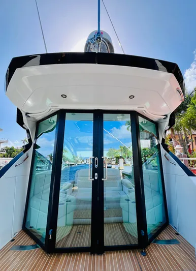 Elixir Yacht Photos Pics 2019 Beneteau Gran Turismo 46 yacht with glass doors and teak deck under sunny sky.