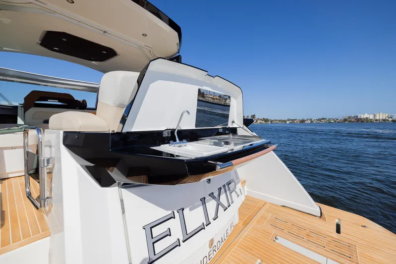 Elixir Yacht Photos Pics 2019 Beneteau Gran Turismo 46 yacht with outdoor sink, docked by the water.