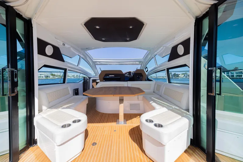 Elixir Yacht Photos Pics Luxurious interior of 2019 Beneteau Gran Turismo 46 yacht with elegant seating and table.