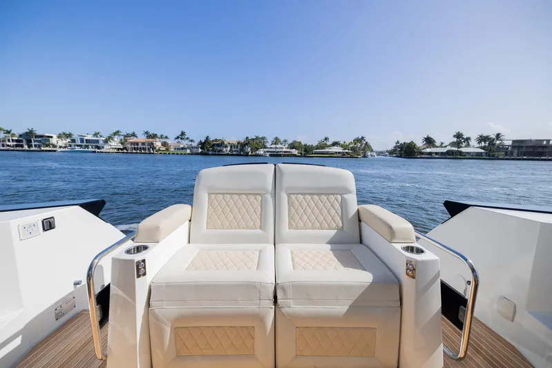 Elixir Yacht Photos Pics Luxurious seating on 2019 Beneteau Gran Turismo 46 yacht, overlooking serene waterfront.