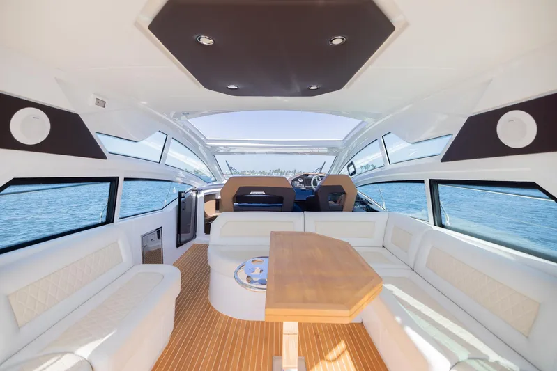 Elixir Yacht Photos Pics Luxurious interior of 2019 Beneteau Gran Turismo 46 yacht with elegant seating and panoramic windows.