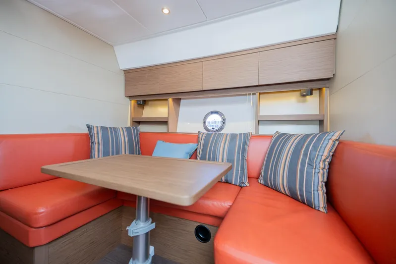 Elixir Yacht Photos Pics 2019 Beneteau Gran Turismo 46 interior with orange seating and striped cushions.