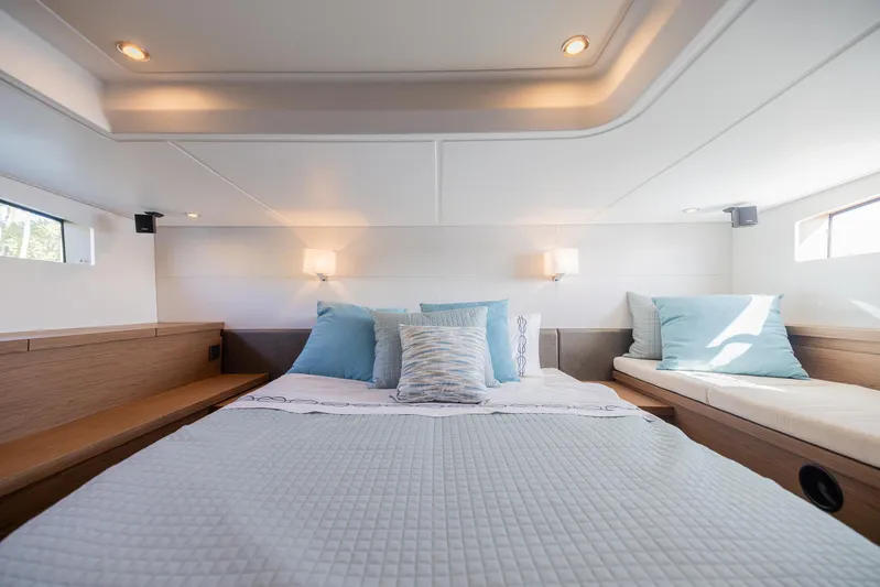 Elixir Yacht Photos Pics Luxurious bedroom interior of 2019 Beneteau Gran Turismo 46 yacht with elegant bedding and lighting.