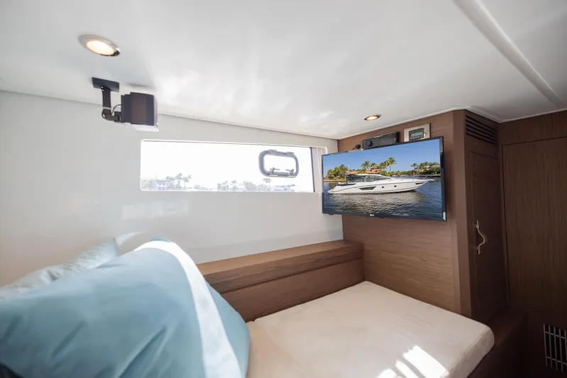 Elixir Yacht Photos Pics Interior cabin of 2019 Beneteau Gran Turismo 46 yacht with bed and TV.