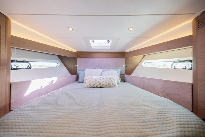 Elixir Yacht Photos Pics Luxurious cabin interior of 2019 Beneteau Gran Turismo 46 yacht, featuring a cozy bed and modern design.
