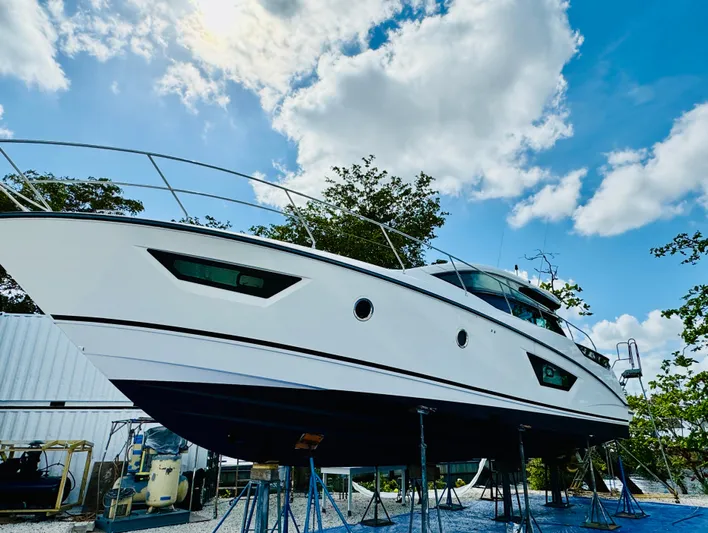 Elixir Yacht Photos Pics 2019 Beneteau Gran Turismo 46 yacht on stands, under a bright blue sky.