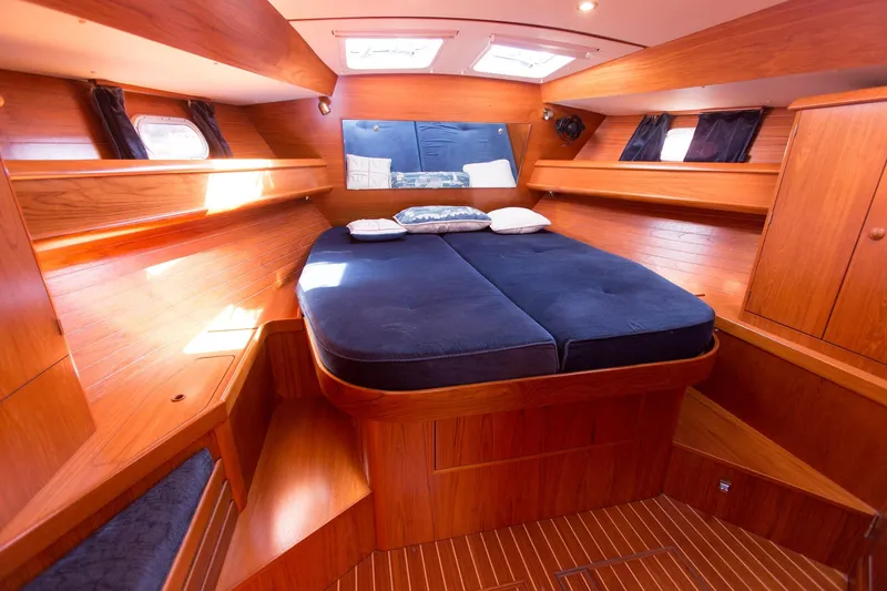 Tangent 2 Yacht Photos Pics Luxurious cabin interior of 2002 Jeanneau Sun Odyssey 45.2 yacht with wooden finish.