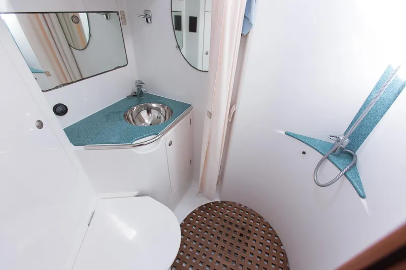 Tangent 2 Yacht Photos Pics Bathroom interior of 2002 Jeanneau Sun Odyssey 45.2 yacht, featuring sink and shower.