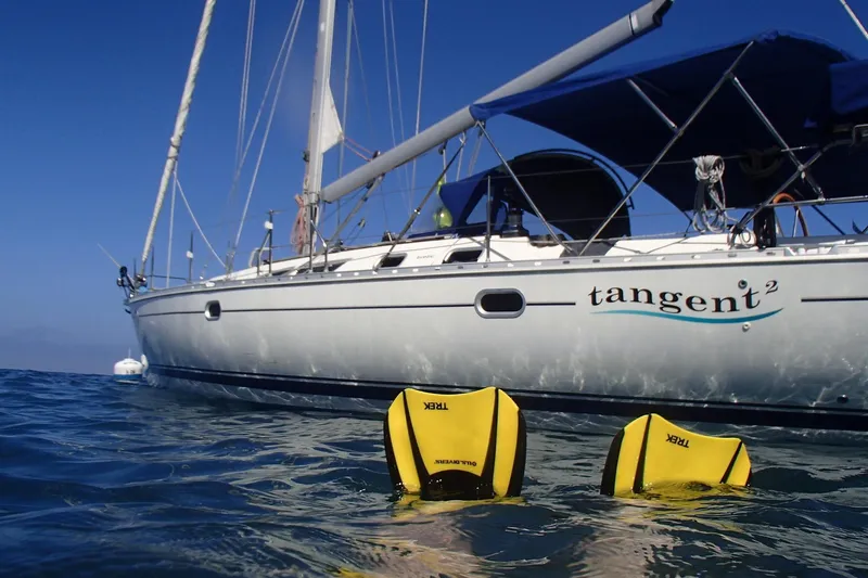 Tangent 2 Yacht Photos Pics Jeanneau Sun Odyssey 45.2 sailboat on water, 2002 model, with diver fins visible.
