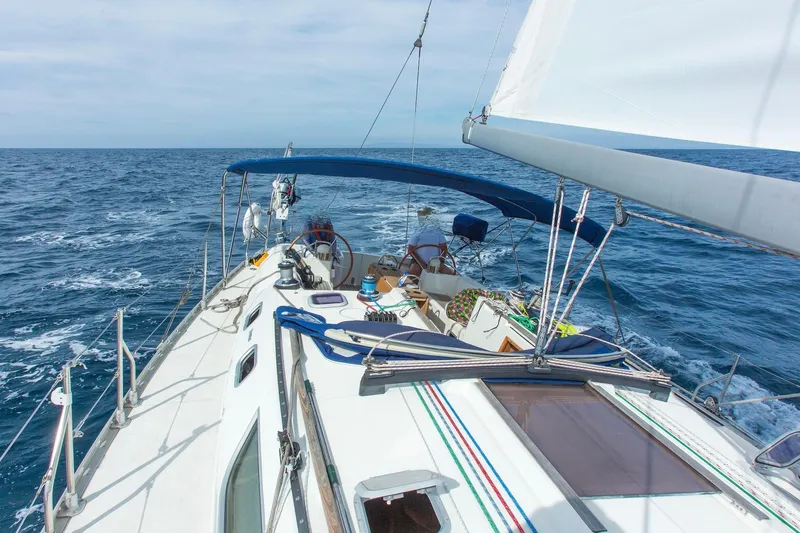 Tangent 2 Yacht Photos Pics Sailing Jeanneau Sun Odyssey 45.2, 2002 model, on open sea with clear skies.