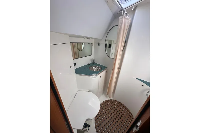 Tangent 2 Yacht Photos Pics Bathroom interior of 2002 Jeanneau Sun Odyssey 45.2 yacht, featuring sink and shower.