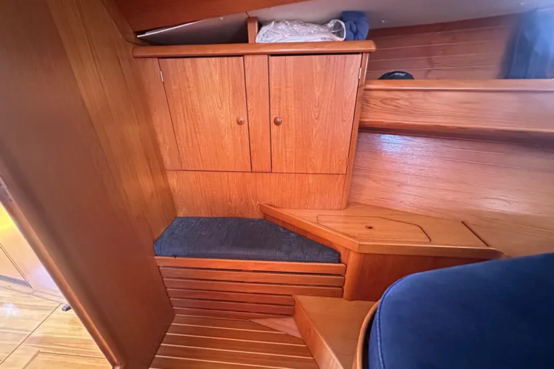 Tangent 2 Yacht Photos Pics Interior of 2002 Jeanneau Sun Odyssey 45.2 yacht with wooden cabinetry and seating.