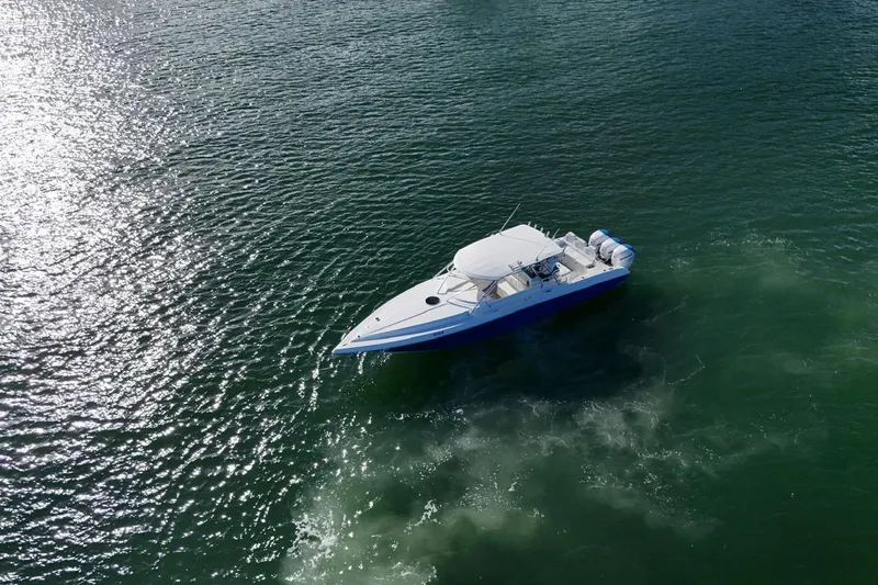  Yacht Photos Pics 2007 Fountain 38 Tournament Edition boat cruising on shimmering water.