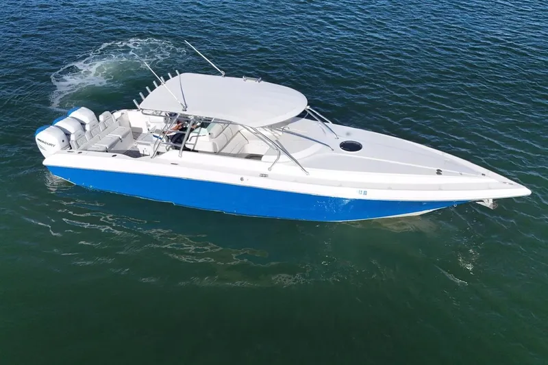  Yacht Photos Pics 2007 Fountain 38 Tournament Edition boat with blue hull cruising on open water.