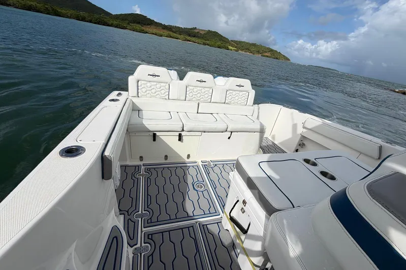  Yacht Photos Pics 2007 Fountain 38 Tournament Edition boat interior with seating, on a scenic water backdrop.