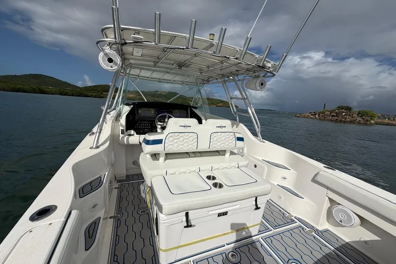  Yacht Photos Pics 2007 Fountain 38 Tournament Edition boat interior with seating and helm, on calm waters.