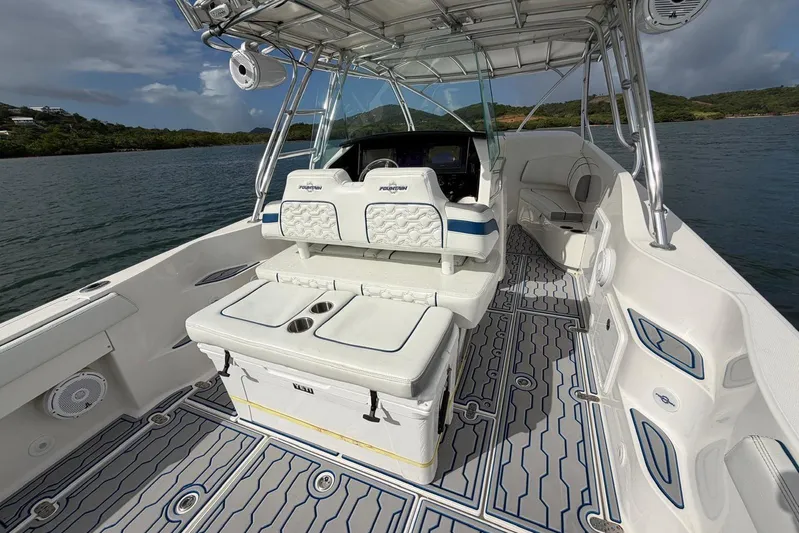 Yacht Photos Pics 2007 Fountain 38 Tournament Edition boat interior with seating and console, on calm water.