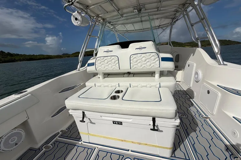  Yacht Photos Pics 2007 Fountain 38 Tournament Edition boat interior with seating and Yeti cooler on deck.