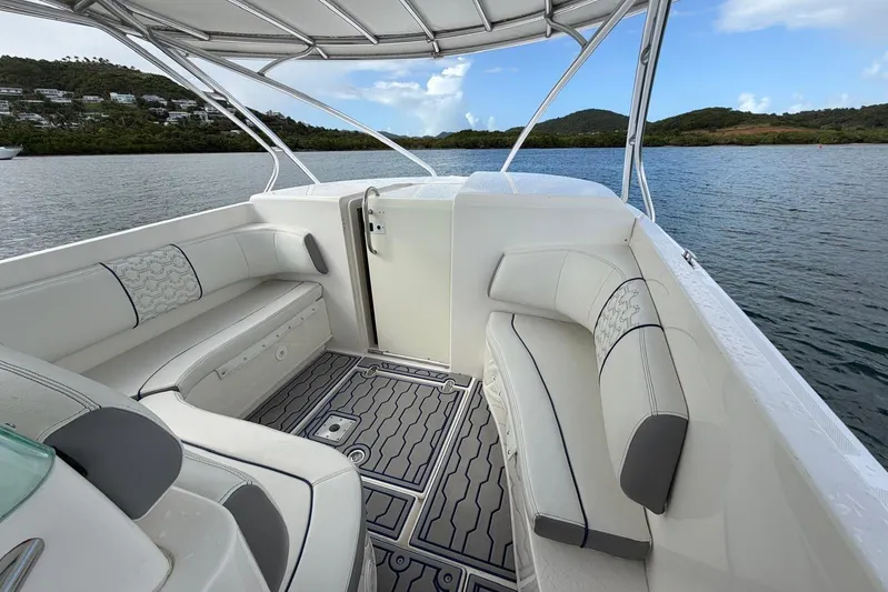  Yacht Photos Pics 2007 Fountain 38 Tournament Edition boat interior with cushioned seating, docked on calm water.