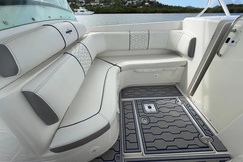  Yacht Photos Pics 2007 Fountain 38 Tournament Edition boat interior with cushioned seating and patterned flooring.