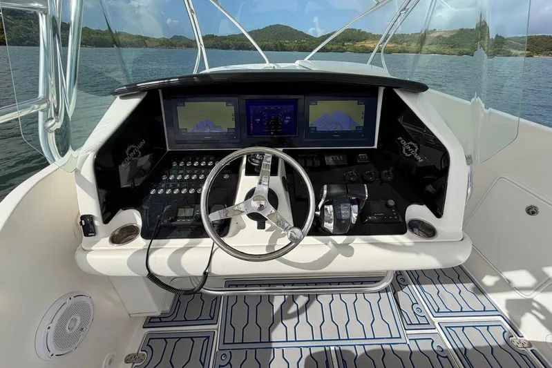  Yacht Photos Pics 2007 Fountain 38 Tournament Edition boat cockpit with steering wheel and navigation screens.
