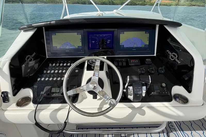  Yacht Photos Pics Control panel of a 2007 Fountain 38 Tournament Edition boat with navigation screens.
